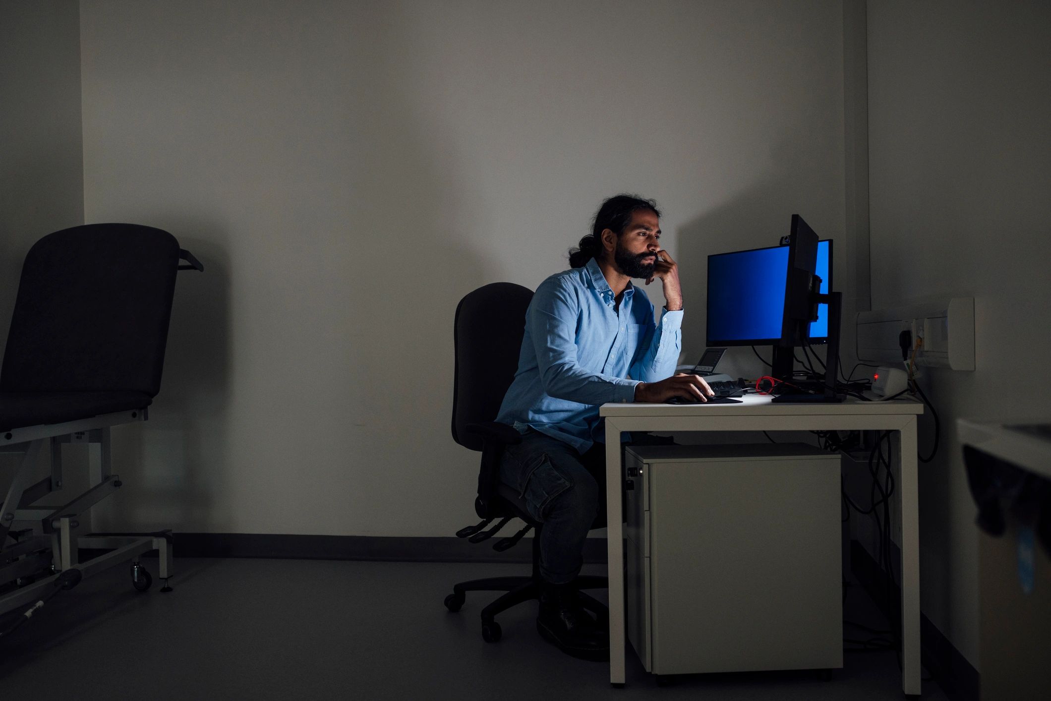 Professional working at a computer during a late shift