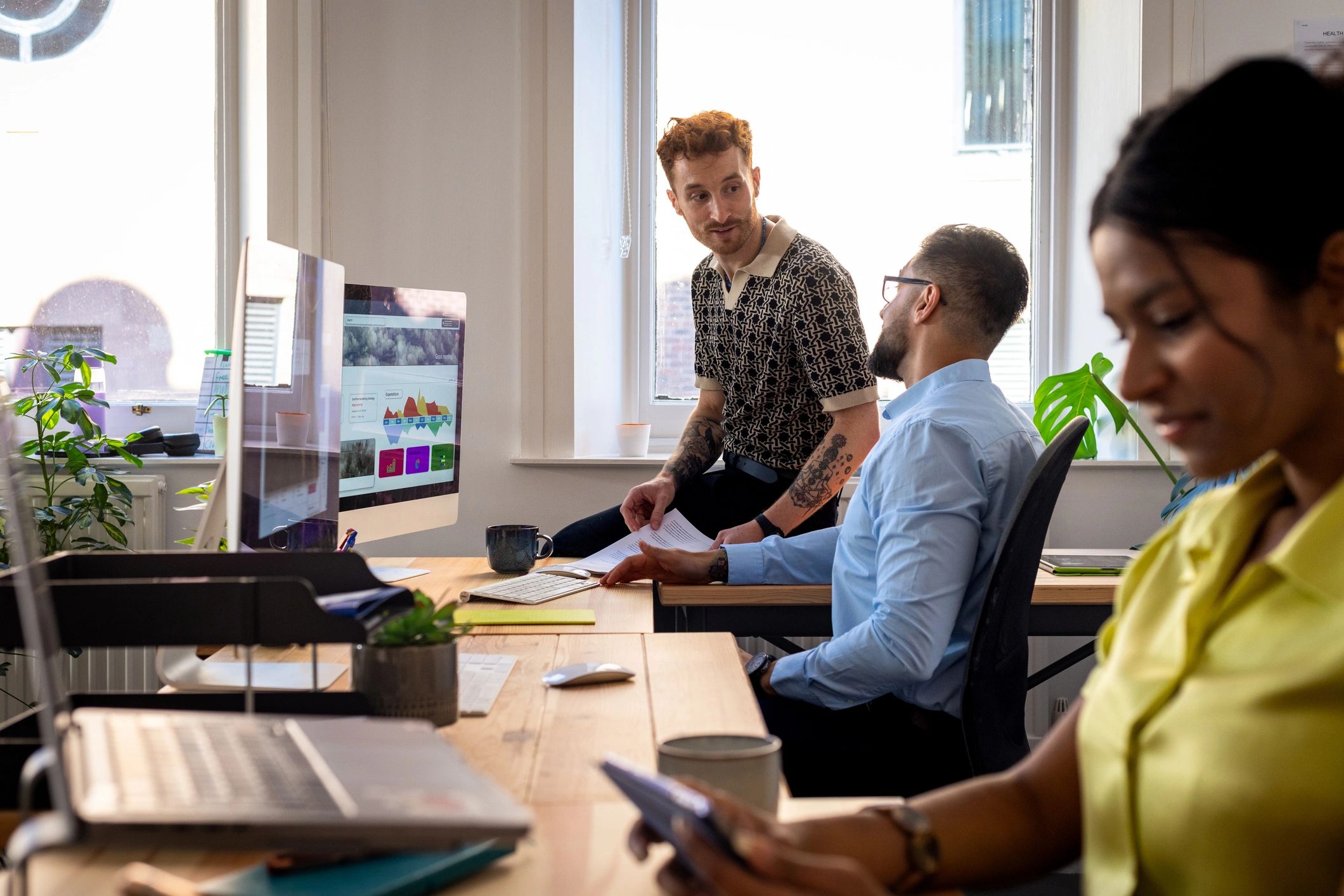 Cybersecurity team discussing work in an office